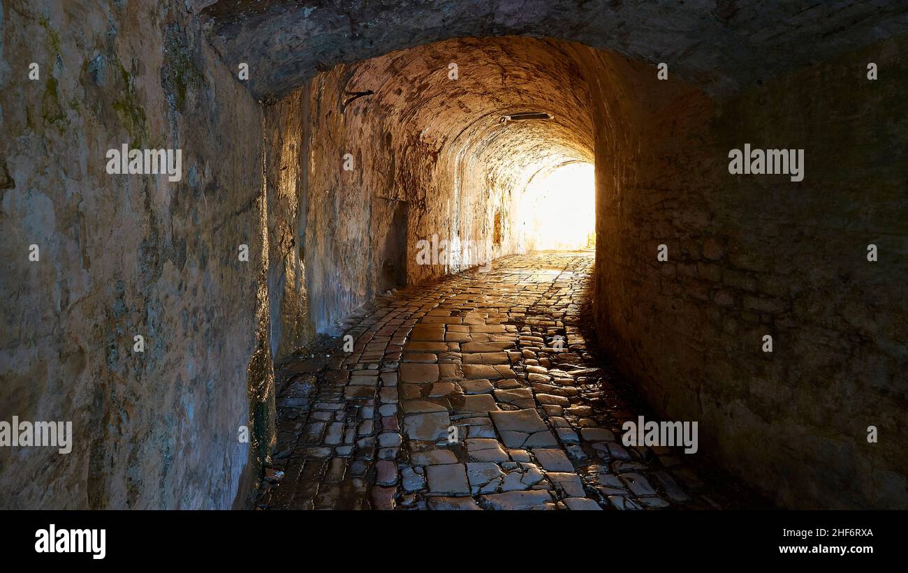 Greece,  Greek Islands,  Ionian Islands,  Corfu,  Corfu Town,  old fortress,  entrance vault,  entrance tunnel,  partly in the shade,  light at the end of the tunnel Stock Photo