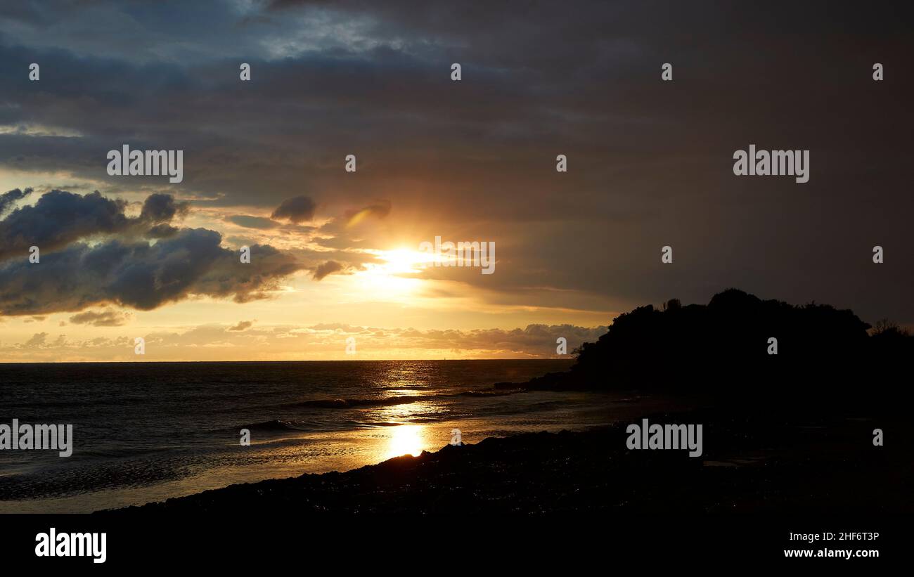 Greece,  Greek islands,  Ionian islands,  Corfu,  west coast,  fresh water lake,  Korission lake,  west coast at sunset directly east of the lake,  sunbeam on the water,  cloudy,  gray sky,  sun shines through Stock Photo