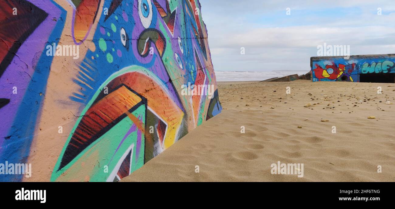 Artistic graffiti on the bunkers on the beach Plage Le Gurp,  France,  Atlantic coast, Stock Photo