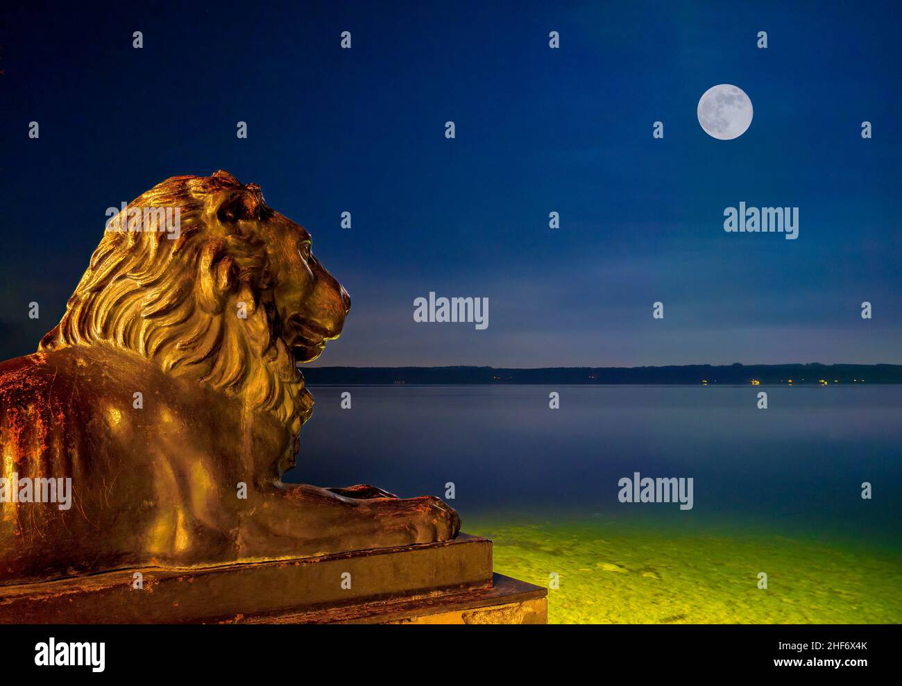 Bavarian lion in front of the Midgardhaus at night,  Tutzing,  Lake Starnberg,  Upper Bavaria,  Bavaria,  Germany Stock Photo