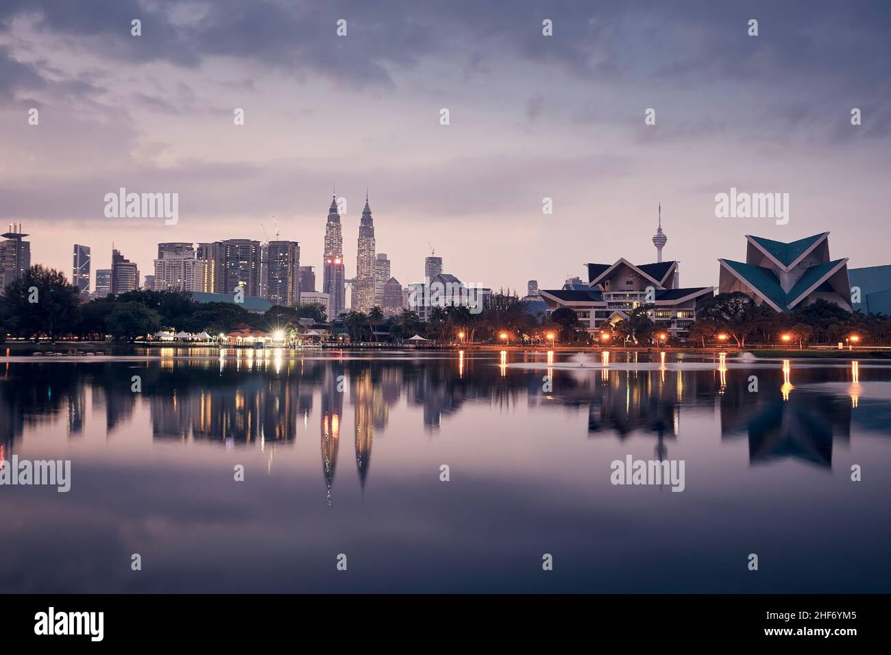 Urban skyline of Kuala Lumpur at dawn. Reflection of skyscrapers in the water surface. Stock Photo