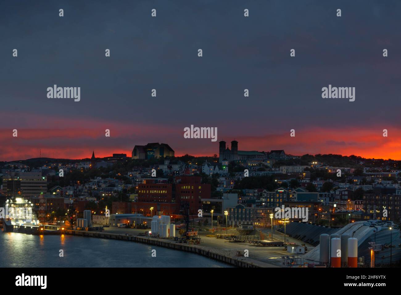 St. John's, Newfoundland, Canada-January 2022: A nighttime view of downtown St. John's skyline with an orange glow in the sky at sunset. Stock Photo