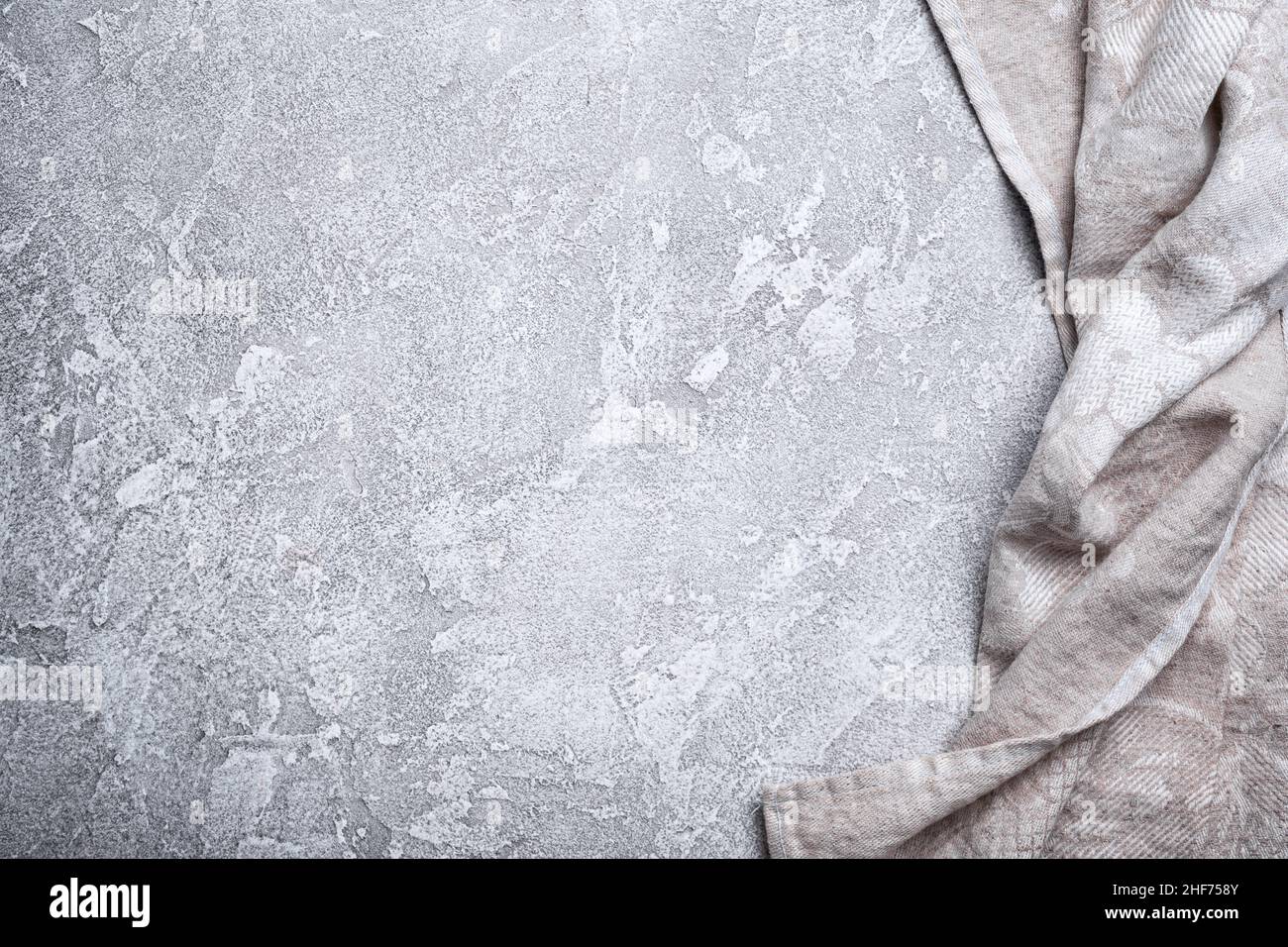 Top view of single folded linen serviette on grey concrete background Stock Photo