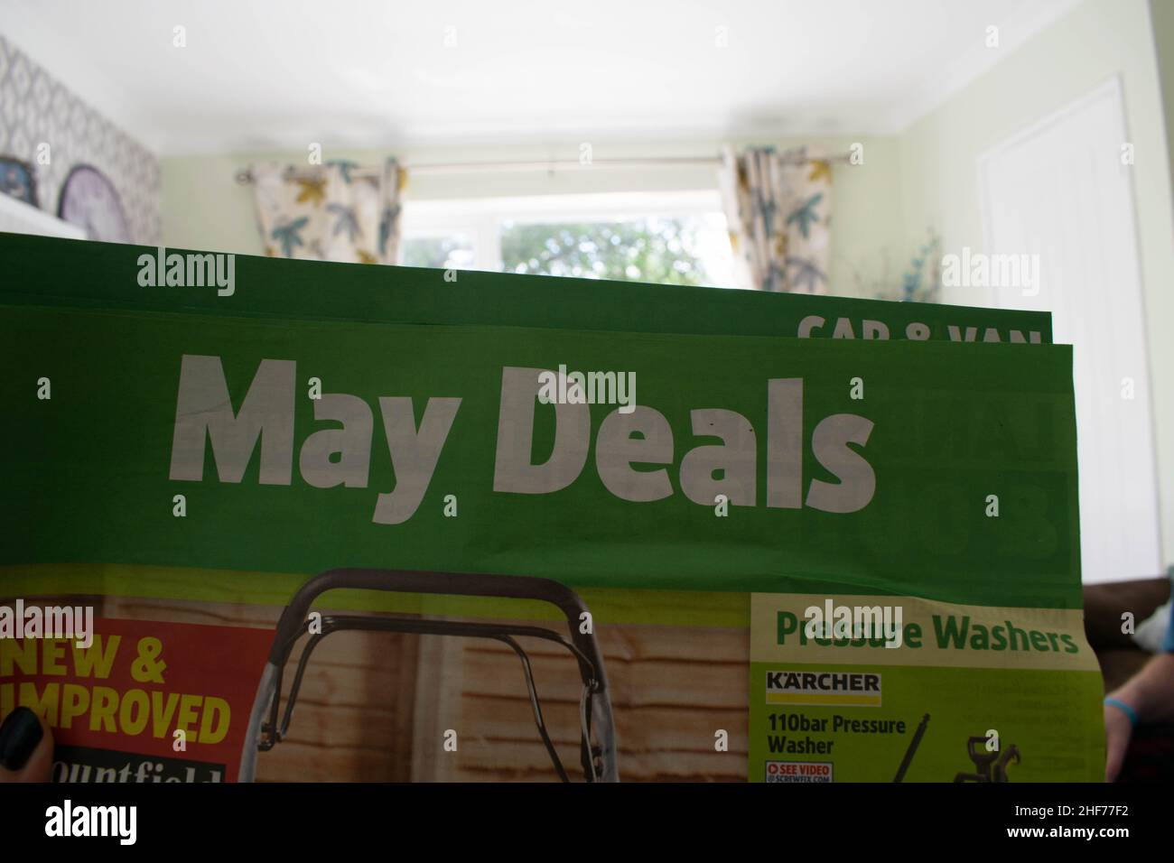 Advert on junk mail through the post advertising the May Spring Sale, huge discounts and low prices to be had on garden equipment. Women's hand Stock Photo