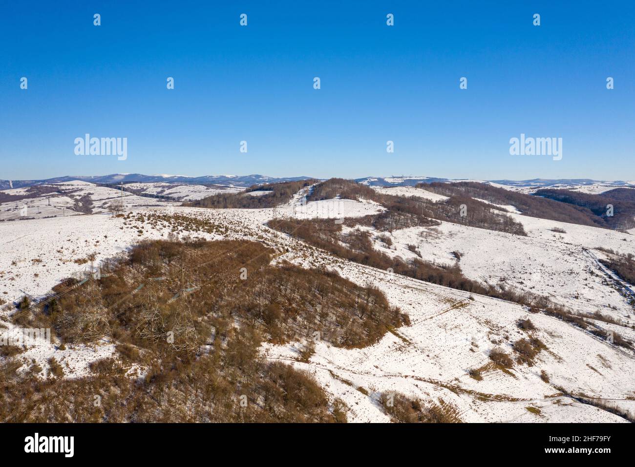 High voltage power lines in the mountains in winter aerial view Stock ...