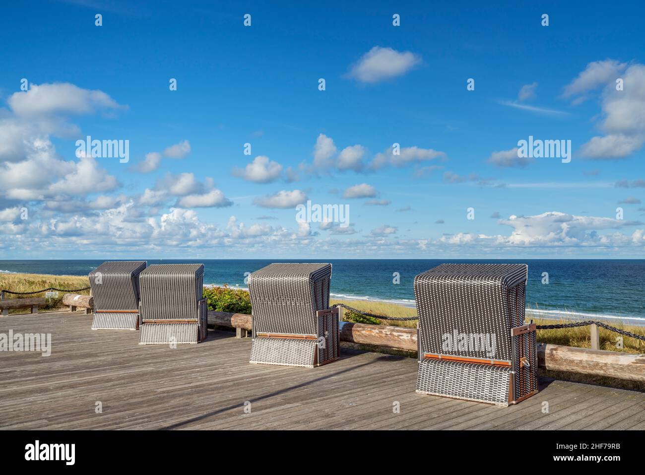 Beach chairs on the promenade above the sea,  Wenningstedt,  Sylt Island,  Schleswig-Holstein,  Germany Stock Photo