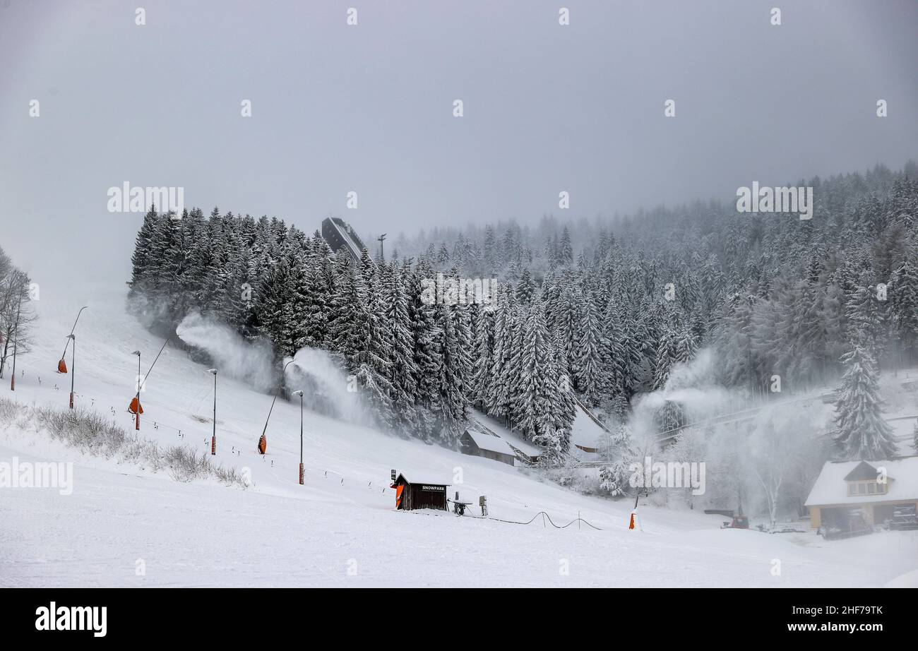12 January 2022, Saxony, Oberwiesenthal: From numerous lances the slope at the Fichtelberg is covered with snow. On Saturday, 15.01.2022, this year's ski season will be officially ushered in at Fichtelberg. Due to Corona, the ski area is only open to vaccinated and recovered skiers (2G), and a mask must be worn when queuing at the lift and in the lift itself. The 2G status is checked before purchasing the ski pass as well as in the ski resort. For this purpose, a control point and a central sales point for lift tickets will be set up in the parking lot of the Fichtelberg cable car. Photo: Jan Stock Photo