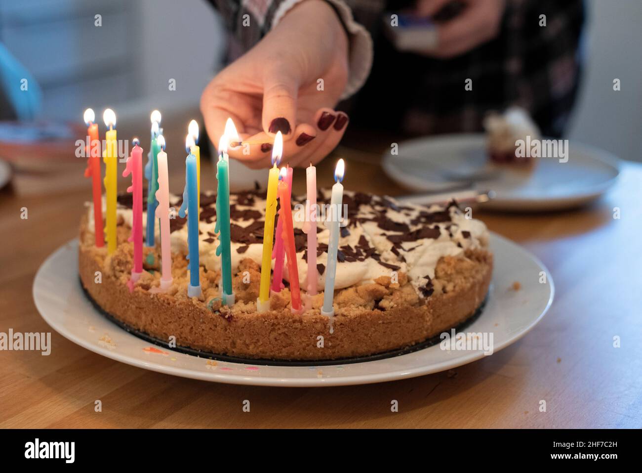 Womans hand lights birthday candles hires stock photography and images