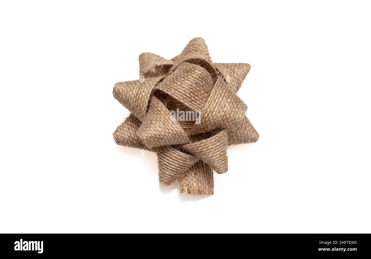 Burlap jute gift bow isolated cutout on white background, design element, Present wrapping decoration Stock Photo