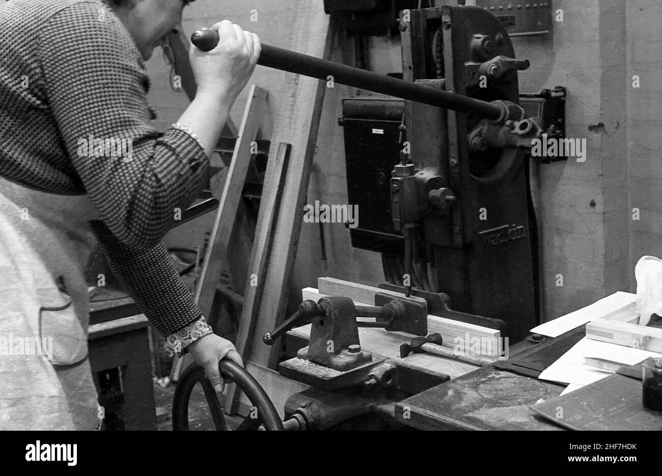 1940s, historical, a lady using a machine in a wood-work class, England ...