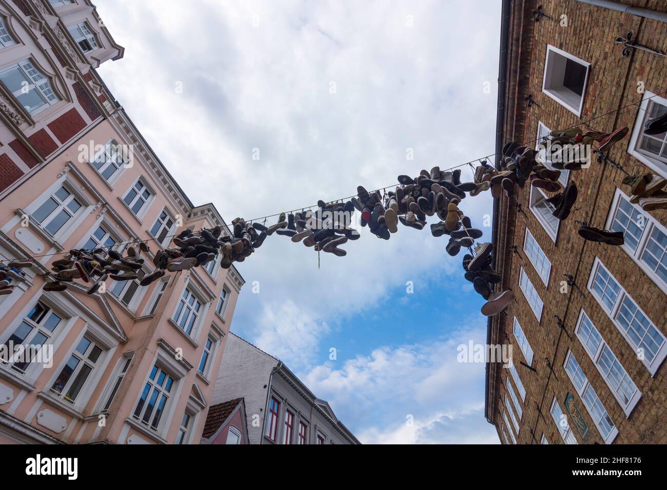 Flensburg,  hanging shoes on Norderstrasse in downtown Flensburg,  Shoefiti in Ostsee (Baltic Sea),  Schleswig-Holstein,  Germany Stock Photo