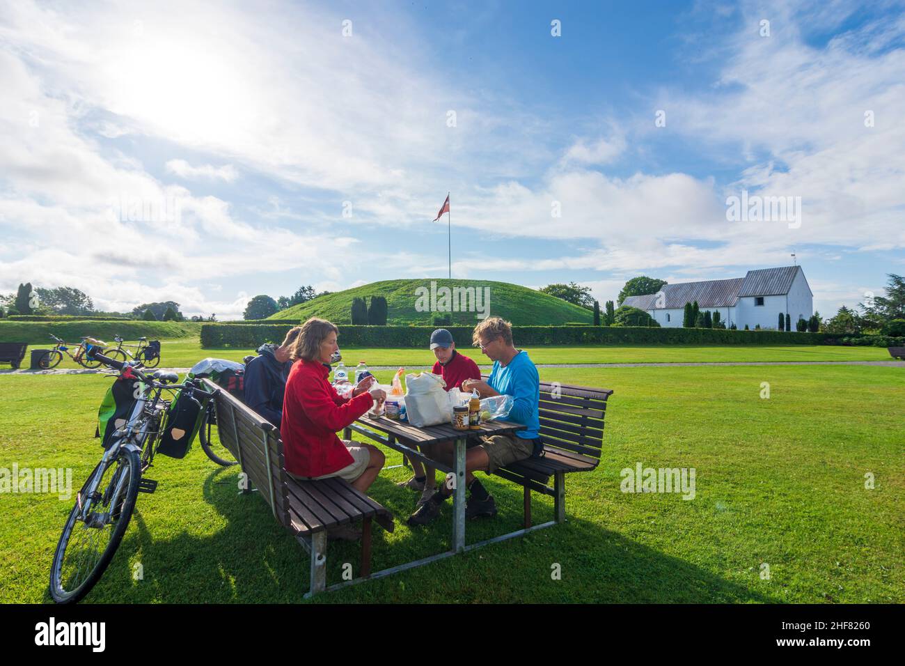 Vejle,  North Mound,  church,  tourists at picnic table in Jelling,  Jylland,  Jutland,  Denmark Stock Photo