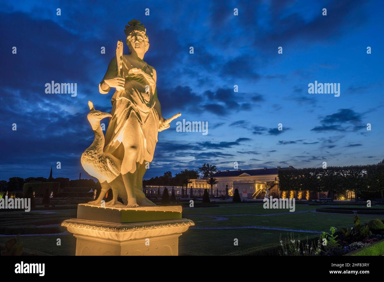 Germany,  Lower Saxony,  Hanover,  sculpture Luft / Juno with peacock in the illuminated Herrenhausen Gardens in the evening Stock Photo