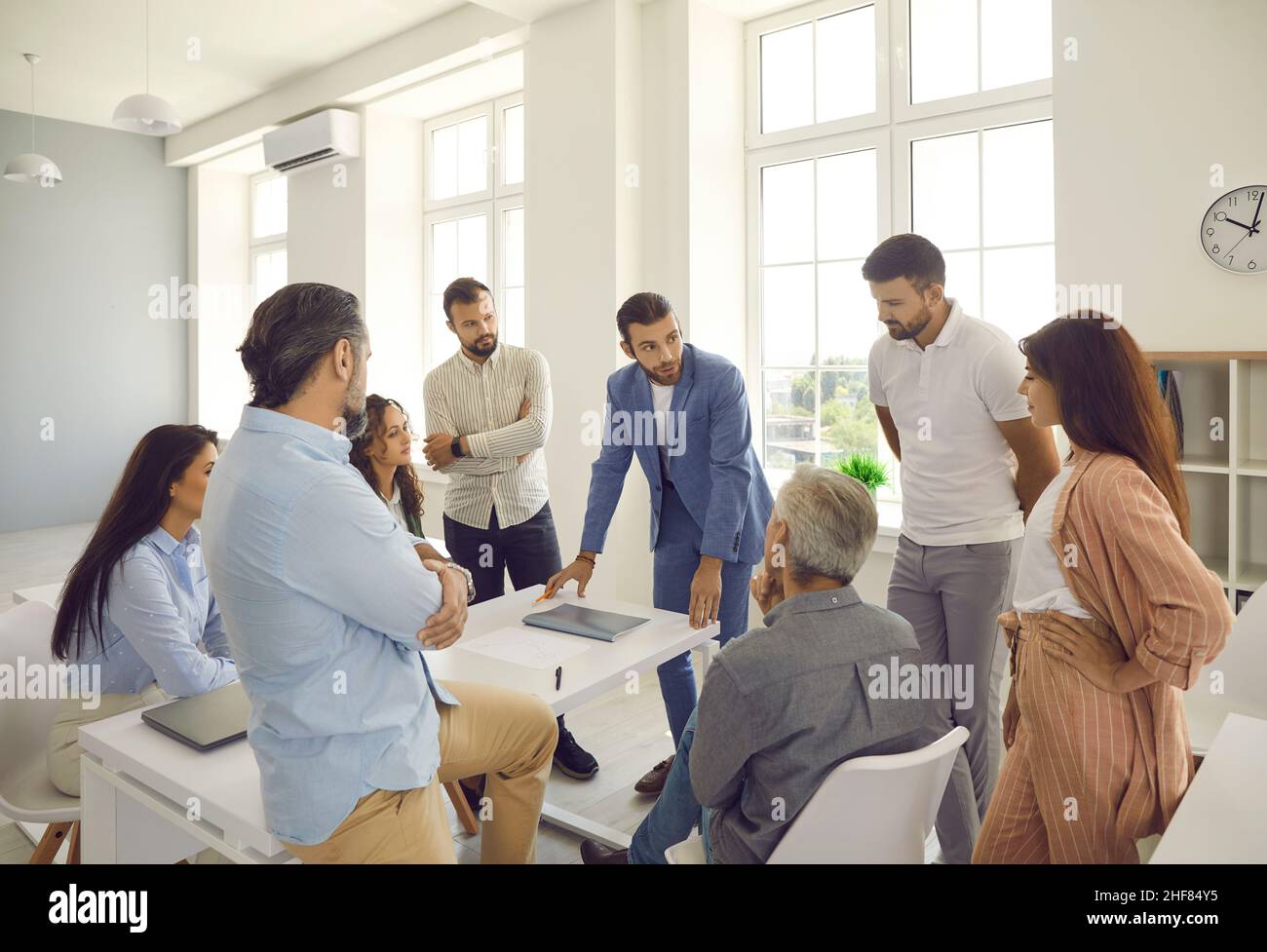 Group of young and senior business people having a discussion during a work meeting Stock Photo