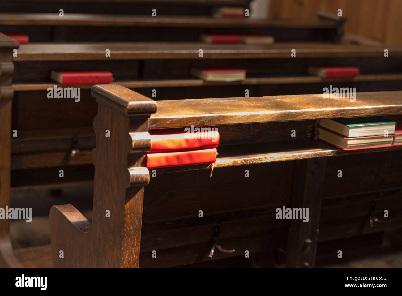 Prayer books, church interior, lights Stock Photo Alamy