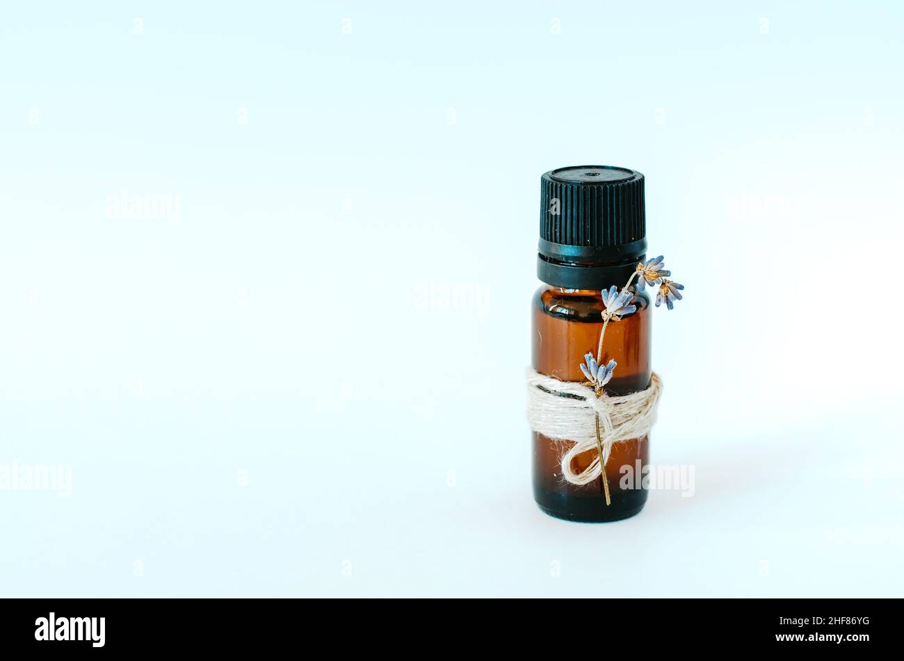 Isolated bottle of essential oil/perfume hand crafted, on white background with copy space Stock Photo