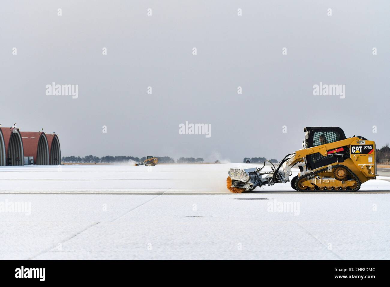 Jan 13, 2022 - Kunsan Air Base, Jeollabuk-do, South Korea - Airmen from the 35th Aircraft Maintenance Unit and 8th Civil Engineer Squadron operate combat track loaders and airfield brushes for snow removal at Kunsan Air Base, Republic of Korea, Jan. 13, 2022. The 8th CES heavy equipment operators, also known as the Dirt Boyz, trained and certified the 35th AMU maintainers to efficiently remove snow and ice, resulting in a mission-ready flightline. Credit: Mya M. Crosby/U.S. Air Force/ZUMA Press Wire Service/ZUMAPRESS.com/Alamy Live News Stock Photo