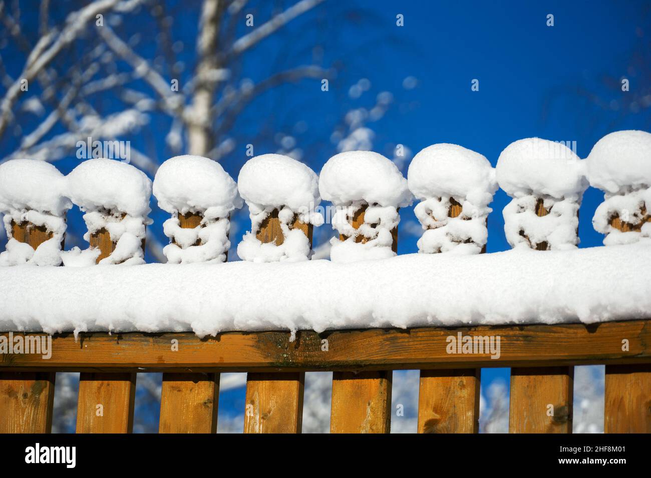 Fresh snow on fence in winter sunny day, Poland Stock Photo