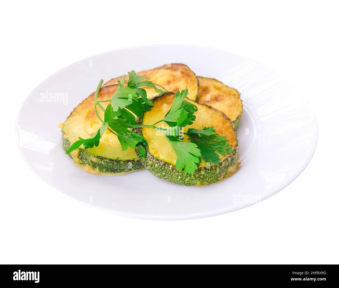 Fried zucchini on a plate isolated on white Stock Photo