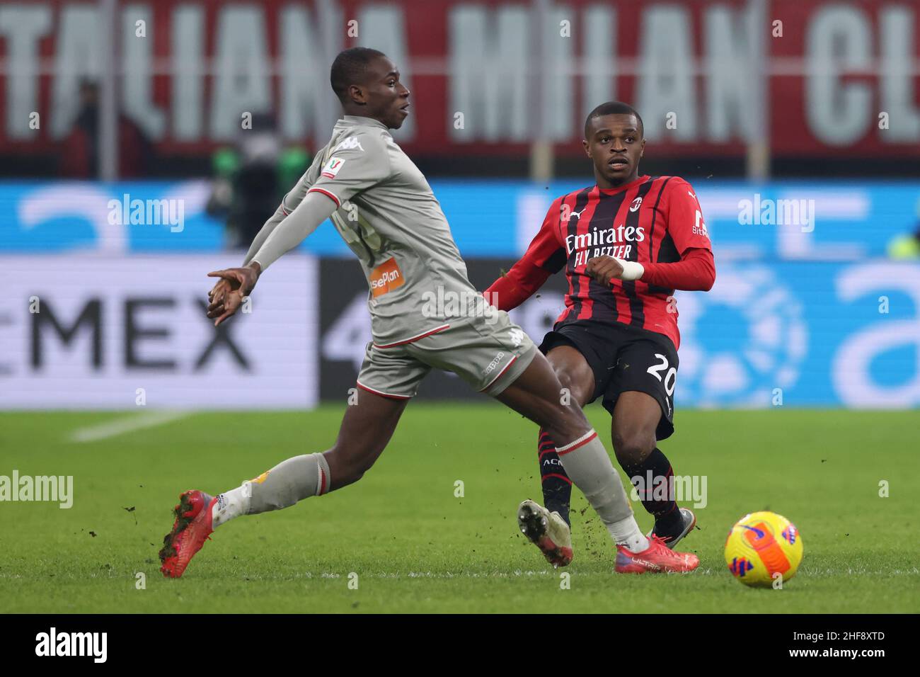 Milan, Italy, 13th January 2022. Pierre Kalulu of AC Milan is challenged by Kevin Yeboah of Genoa CFC during the Coppa Italia match at Giuseppe Meazza, Milan. Picture credit should read: Jonathan Moscrop / Sportimage Stock Photo