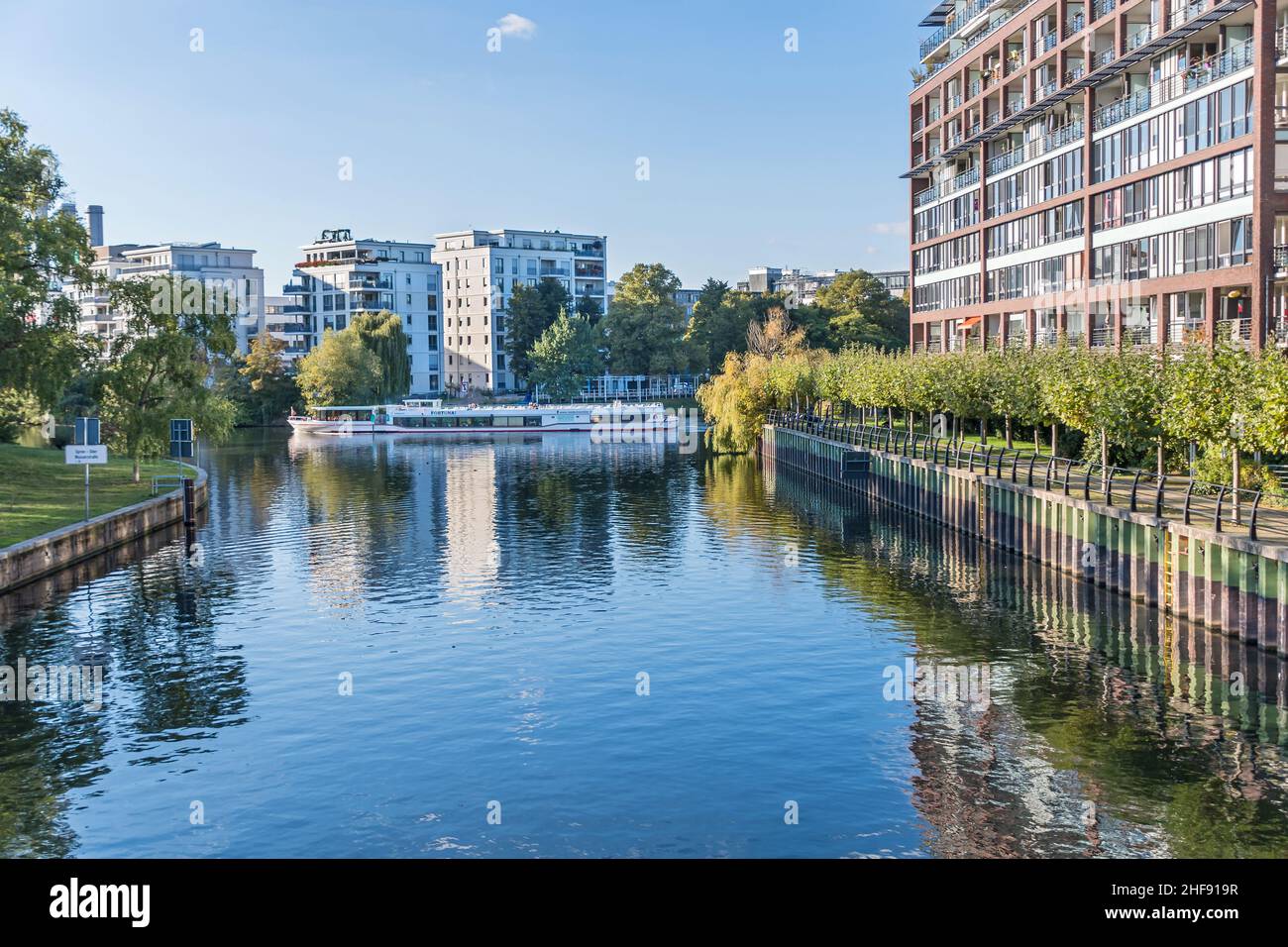 Berlin, Germany - October 7, 2021: Banks of the Landwehr Canal Salzufer and Einsteinufer with modern residential houses and sightseeing boat Fortuna a Stock Photo