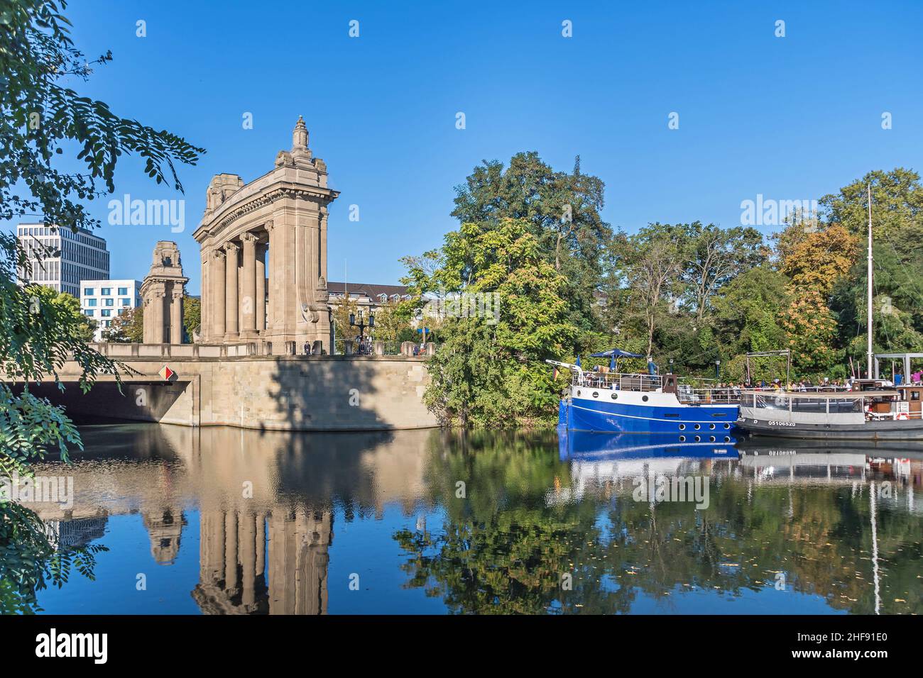 Berlin, Germany - October 7, 2021: Charlottenburg Gate with Charlottenburg Bridge, a Neo-Baroque structure reflecting in the water of the Landwehr Can Stock Photo