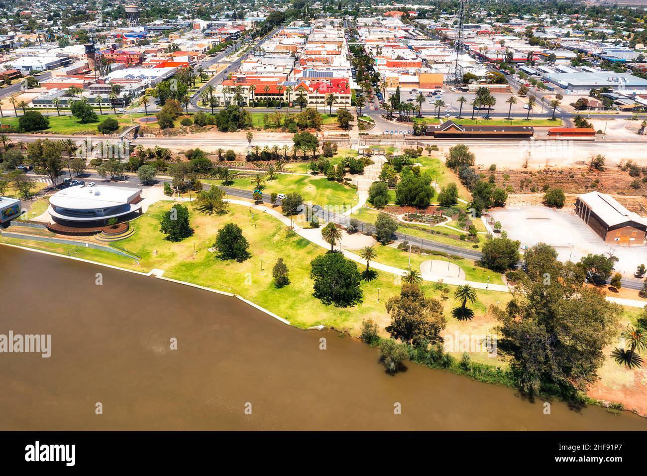 Waterfront of Mildura city on Murray river with train station and downtown - aerial cityscape. Stock Photo