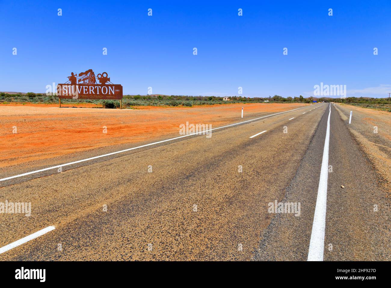 Roadside of highway from Broken Hill to Silverton town in red soil Australian ouback with historic roadsign. Stock Photo