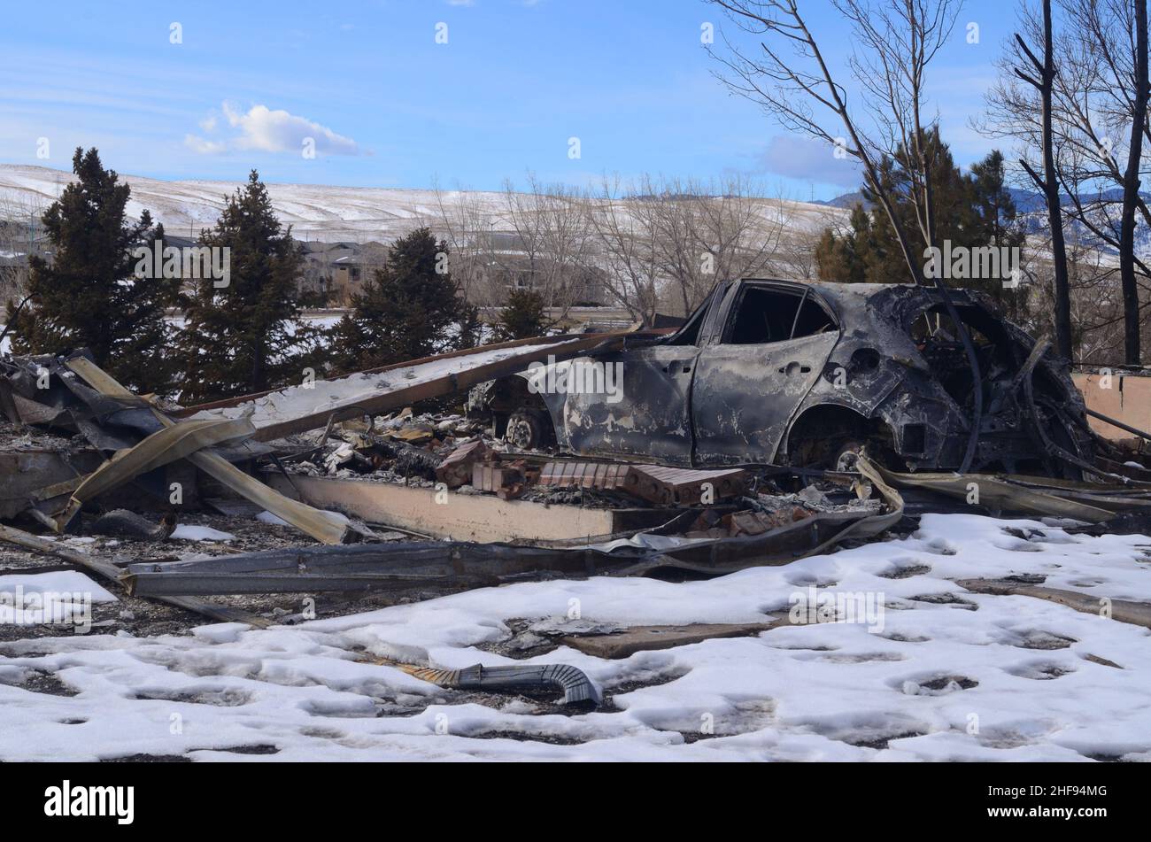 A burned car sits where a garage once was. Superior Colorado. Marshall Fire. Boulder County. Stock Photo