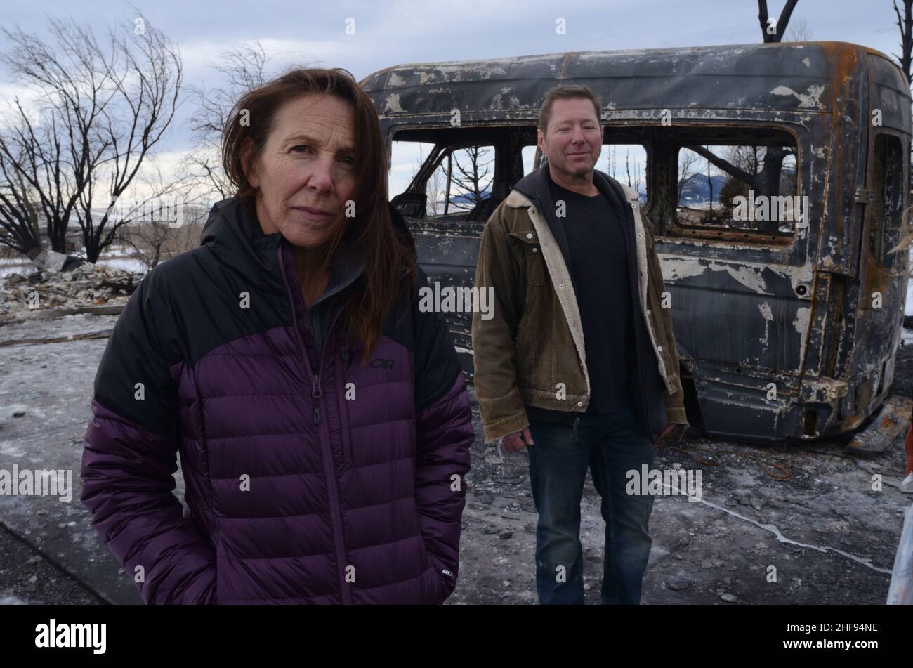 Marshall Fire victims Cheryl and Nathan Ruff stand in front of a burned-out van in what used to be their garage. The Ruffs have two children. Stock Photo