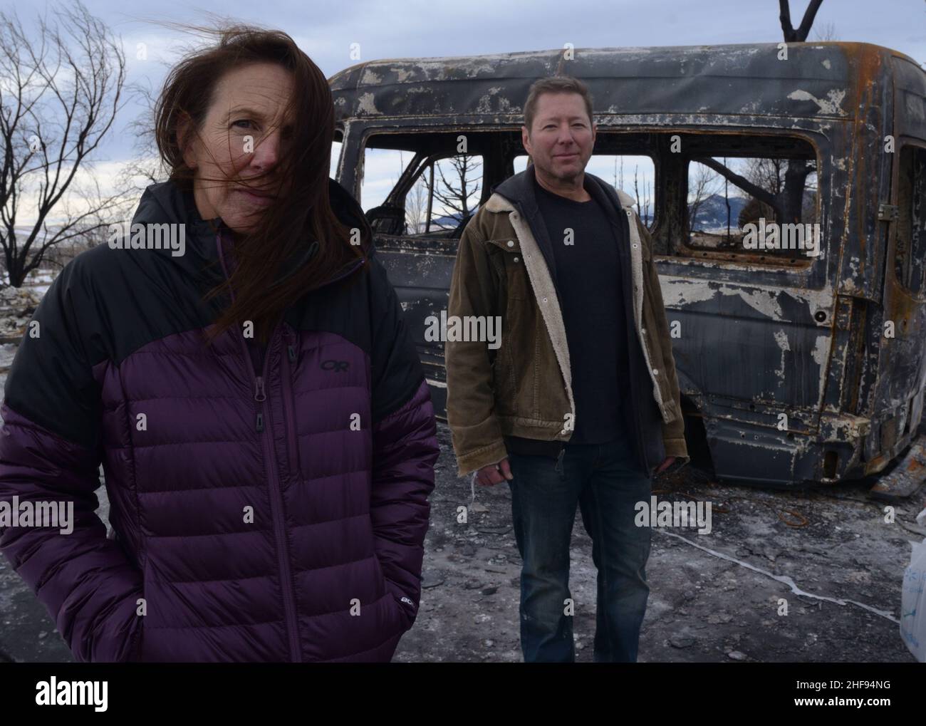 Marshall Fire victims Cheryl and Nathan Ruff stand in front of a burned-out van in what used to be their garage. The Ruffs have two children. Stock Photo