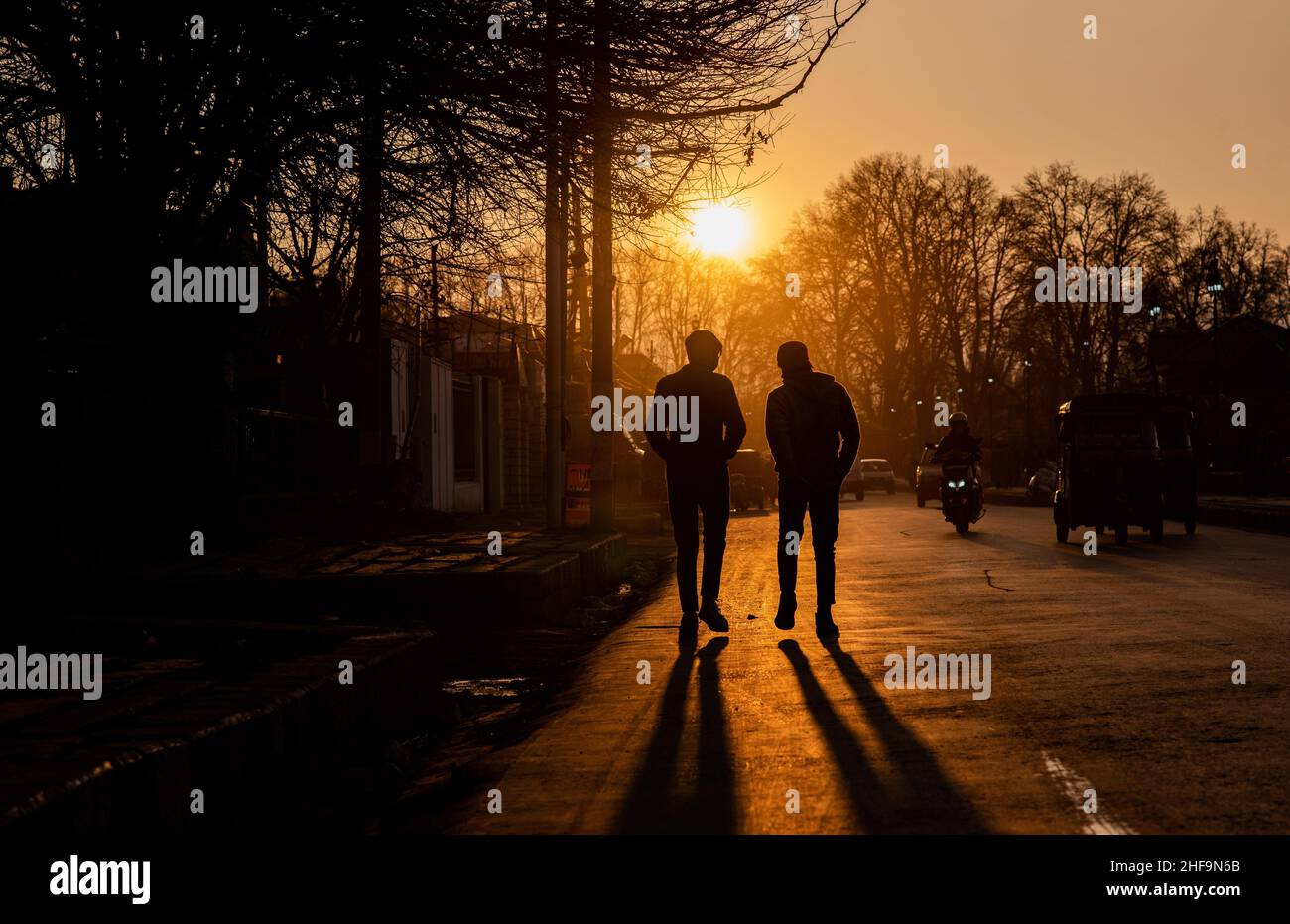 Srinagar, India. 11th Jan, 2022. Silhouette of people walking along the road during sunset. (Photo by Idrees Abbas/SOPA Images/Sipa USA) Credit: Sipa USA/Alamy Live News Stock Photo