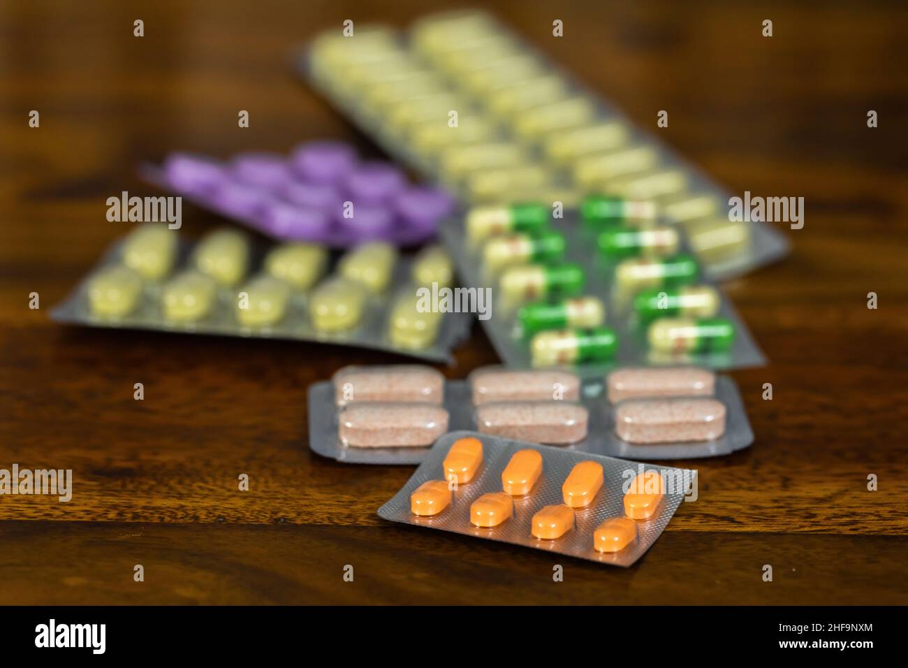 Allopathic medicines displayed on a wooden background with copy space Stock Photo