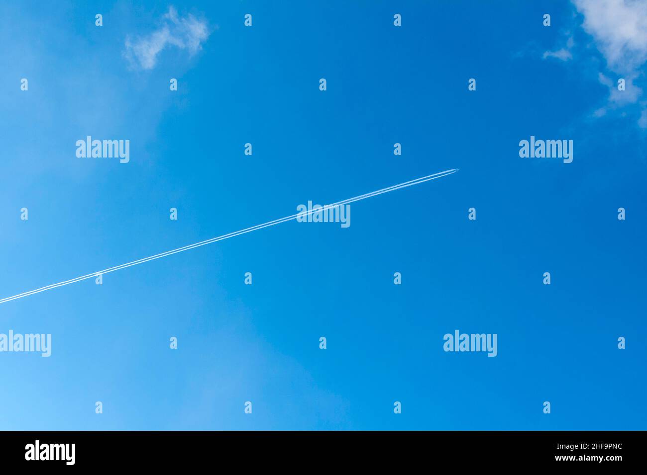 blue sky with condensation trail of aircraft Stock Photo - Alamy