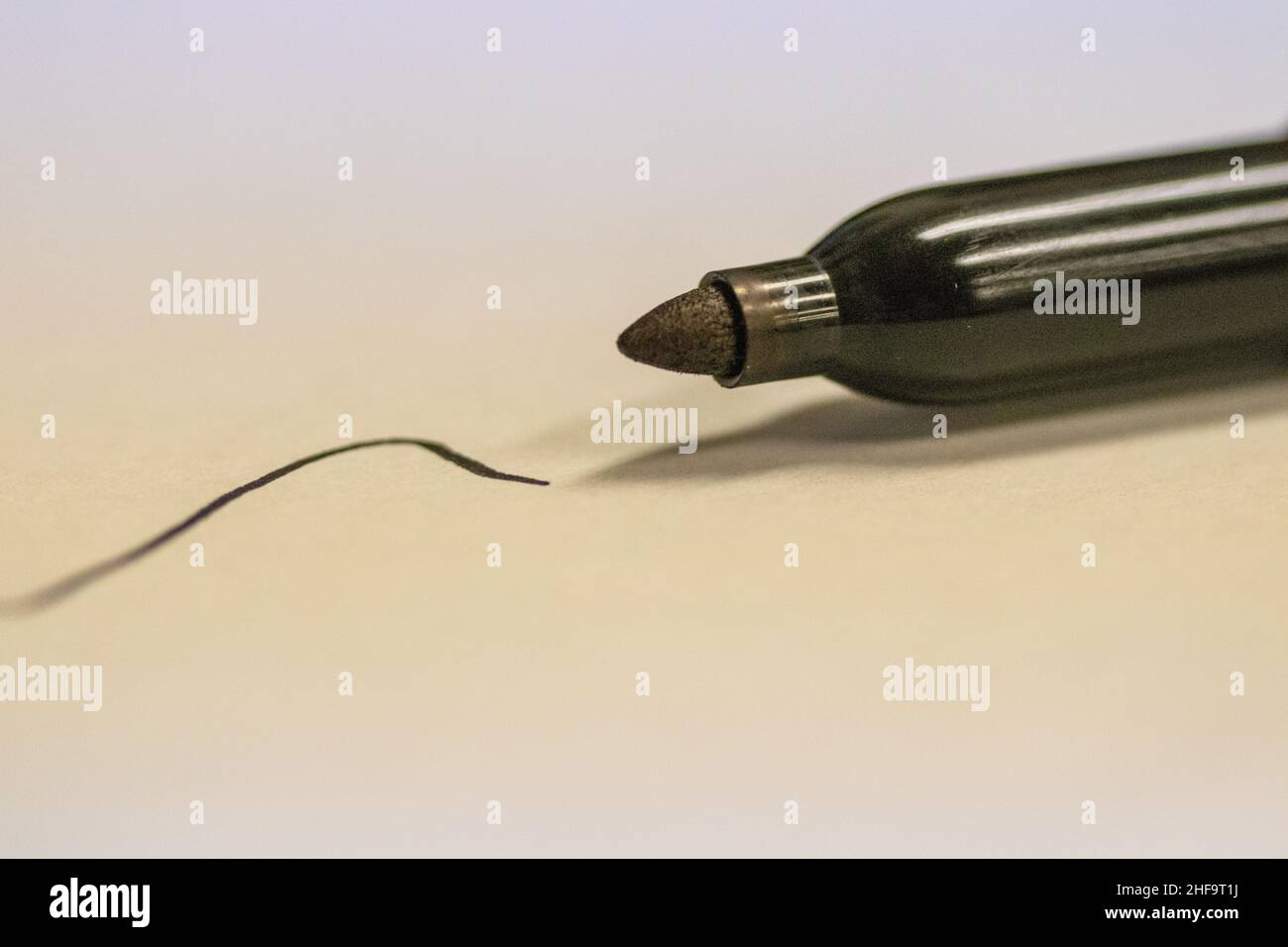 Permanent sharpie Marker close up written black line on white paper