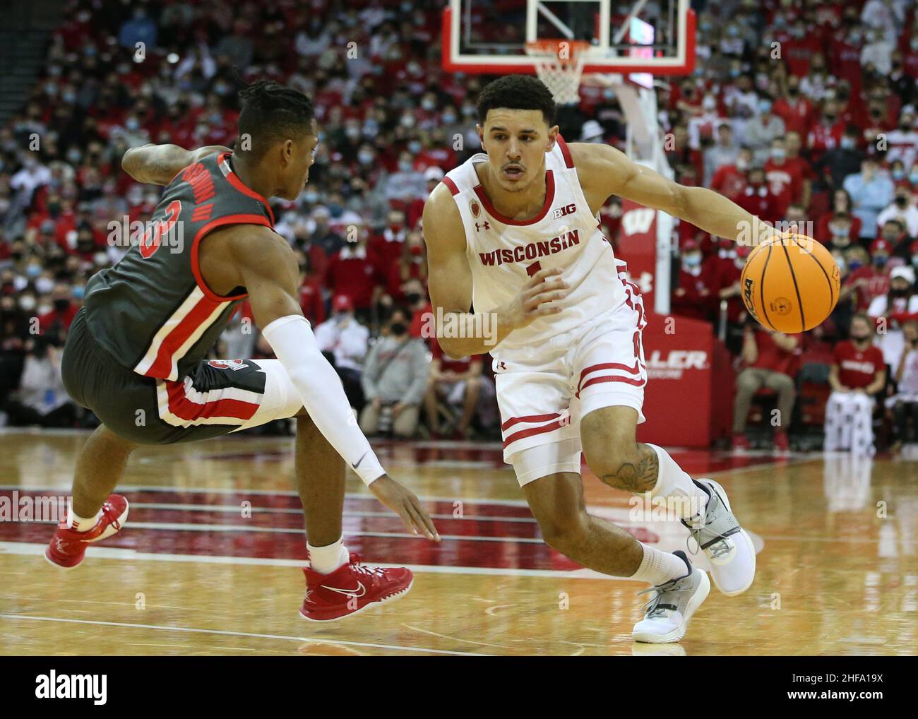 Madison, WI, USA. 13th Jan, 2022. Wisconsin Badgers guard Johnny Davis (1) fakes Ohio State Buckeyes guard Eugene Brown III (3) off his feet during the NCAA Basketball game between the Ohio State Buckeyes and the Wisconsin Badgers at the Kohl Center in Madison, WI. Darren Lee/CSM/Alamy Live News Stock Photo