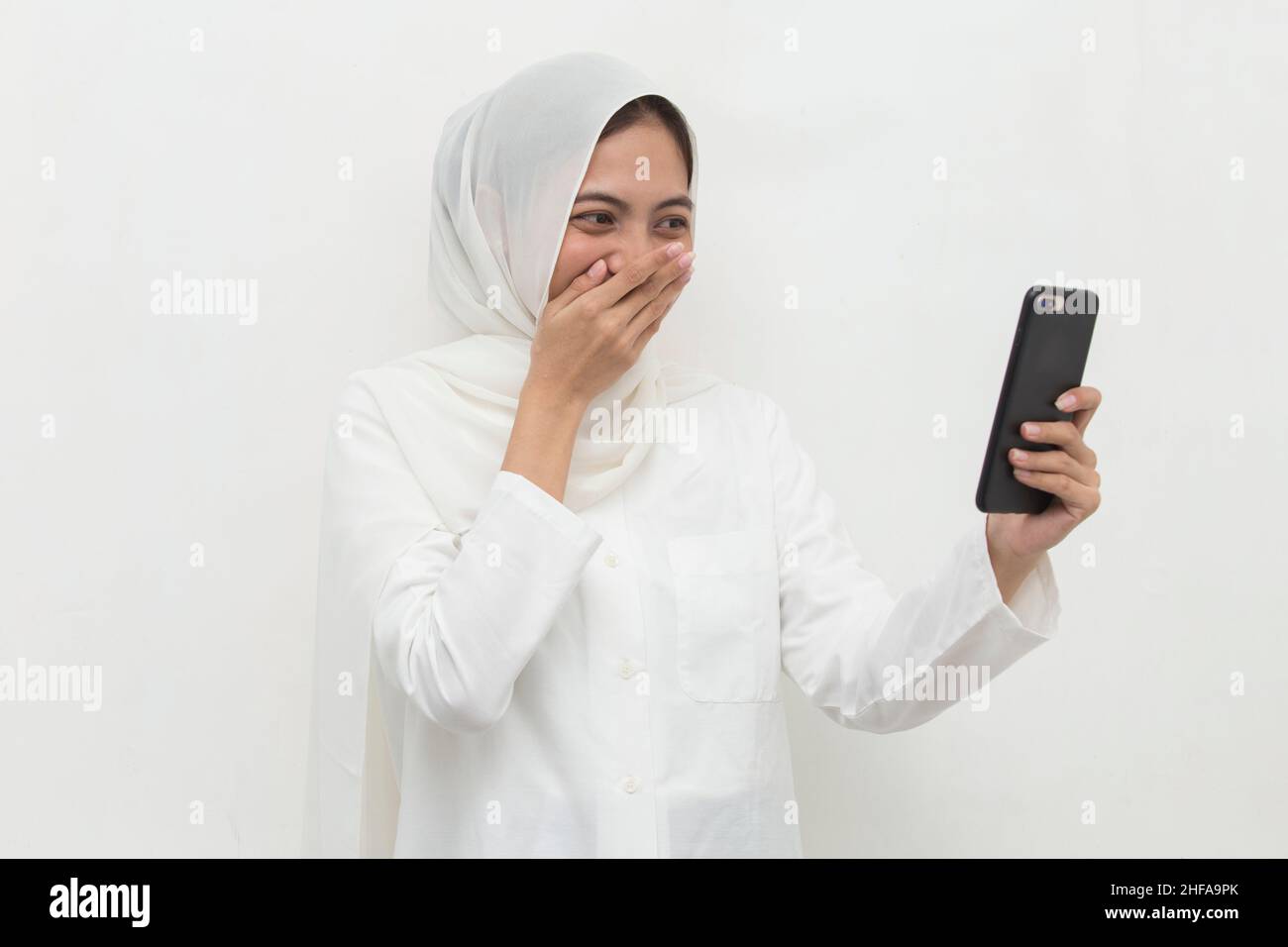 happy young asian muslim woman using mobile phone Stock Photo - Alamy