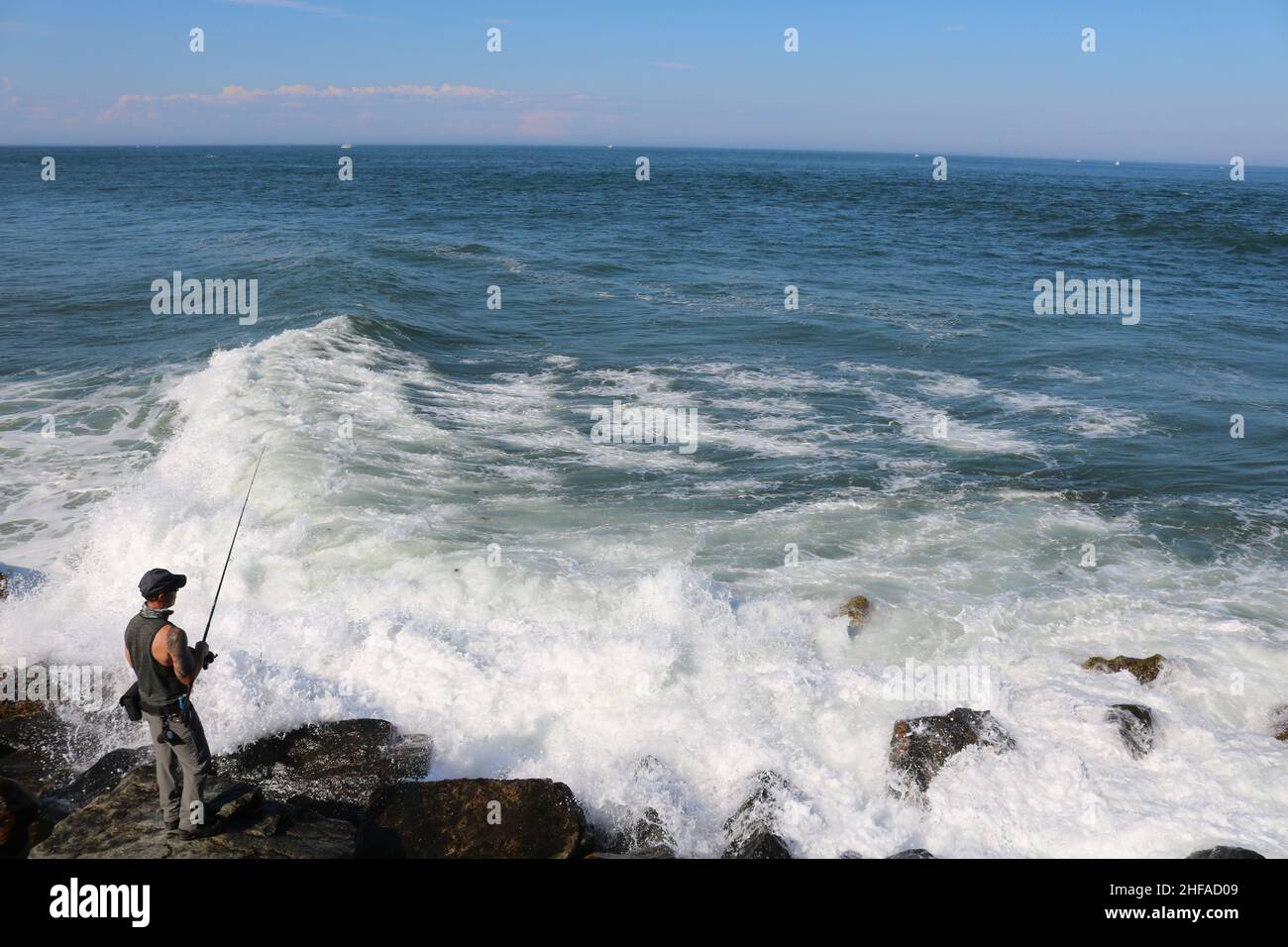 Fishing on rocks Stock Photo Alamy