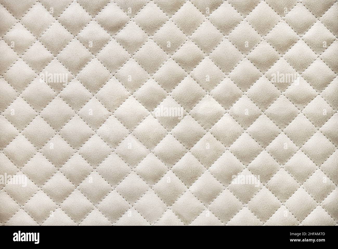 Elegant wardrobe facades covered with light beige alcantara quilted by rhomb pattern close view Stock Photo