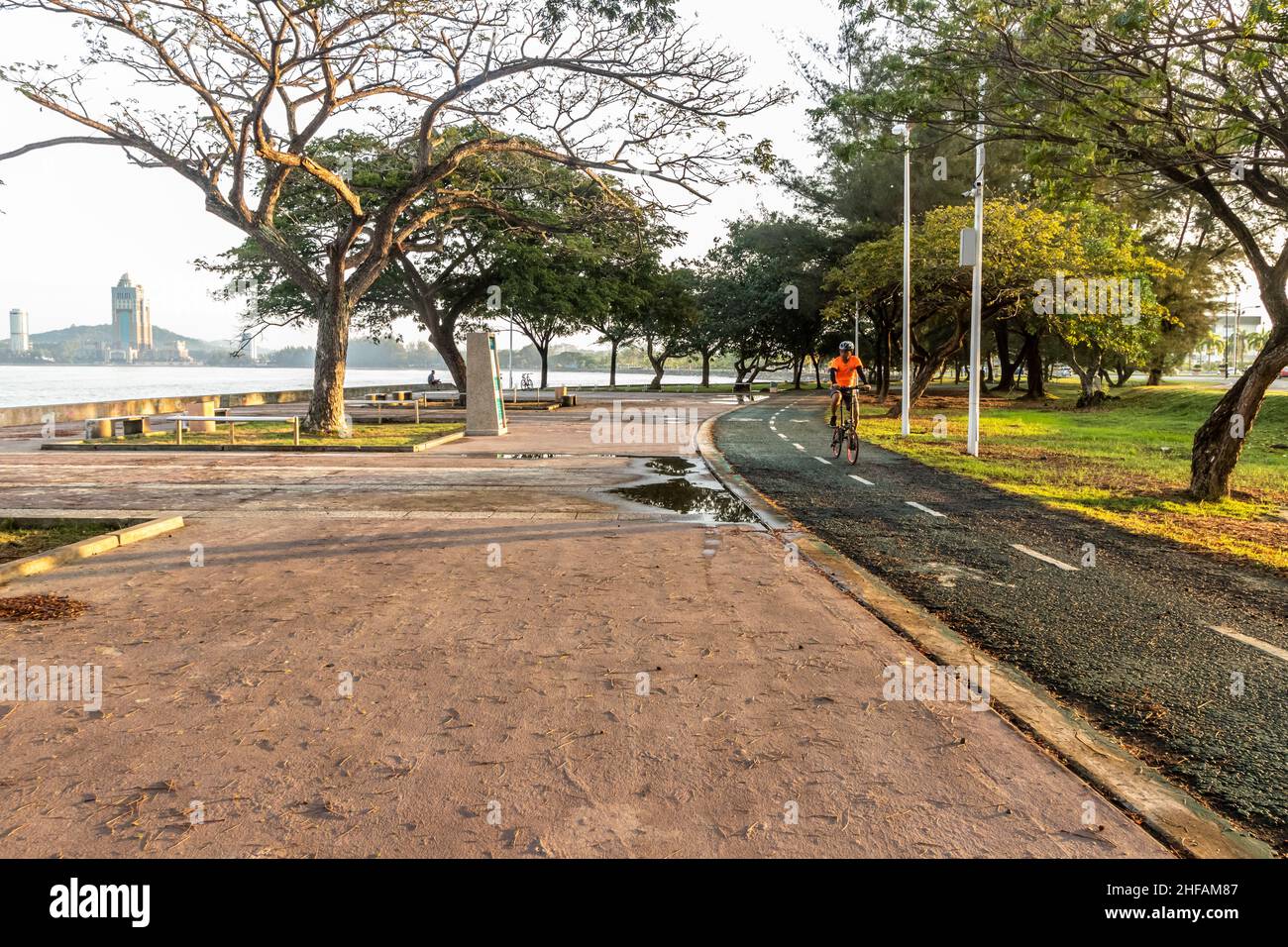 Locals cycling, jogging and running at Likas bay purpose built jogging