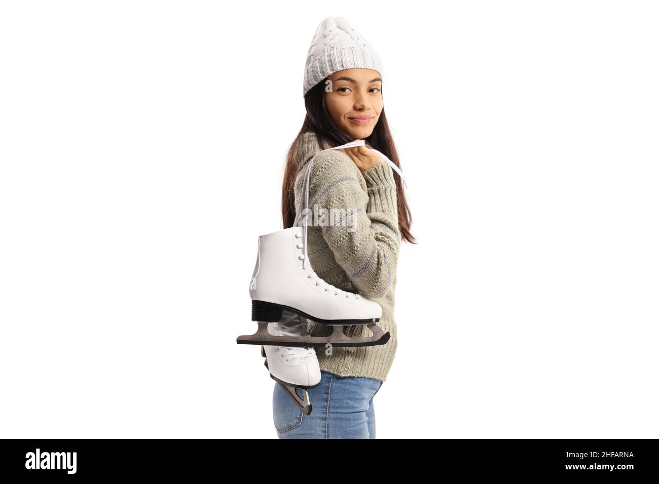 Beautiful young woman carrying iceskates on her shoulder and smiling