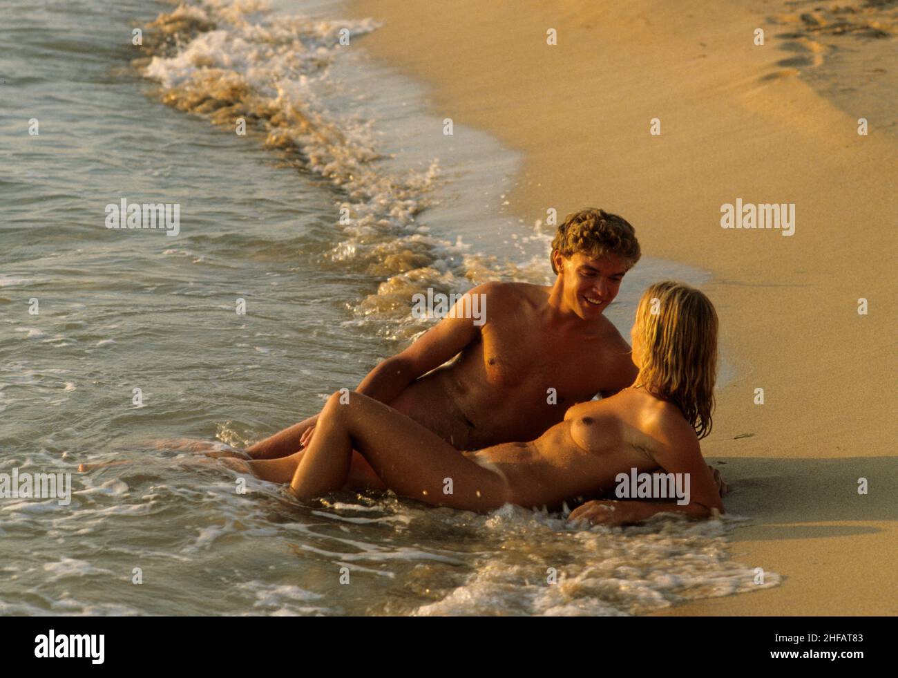 nudist cople 1 young couple embrace nude lovers on beach sunset topless naturist Stock  Photo - Alamy