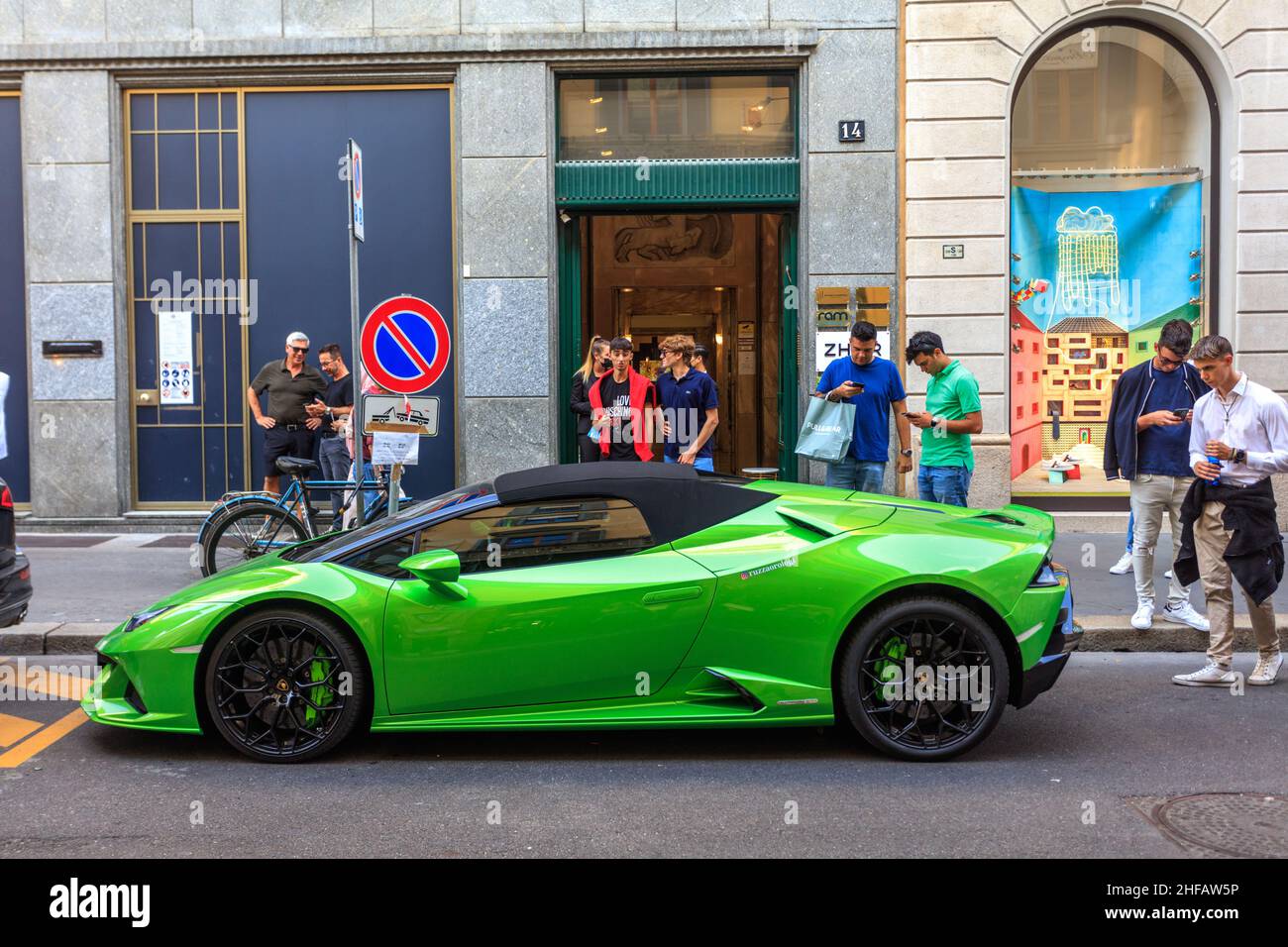 A green Lamborghini sports car parked in the fashion district Monte Napoleone of Milan, Italy. Stock Photo