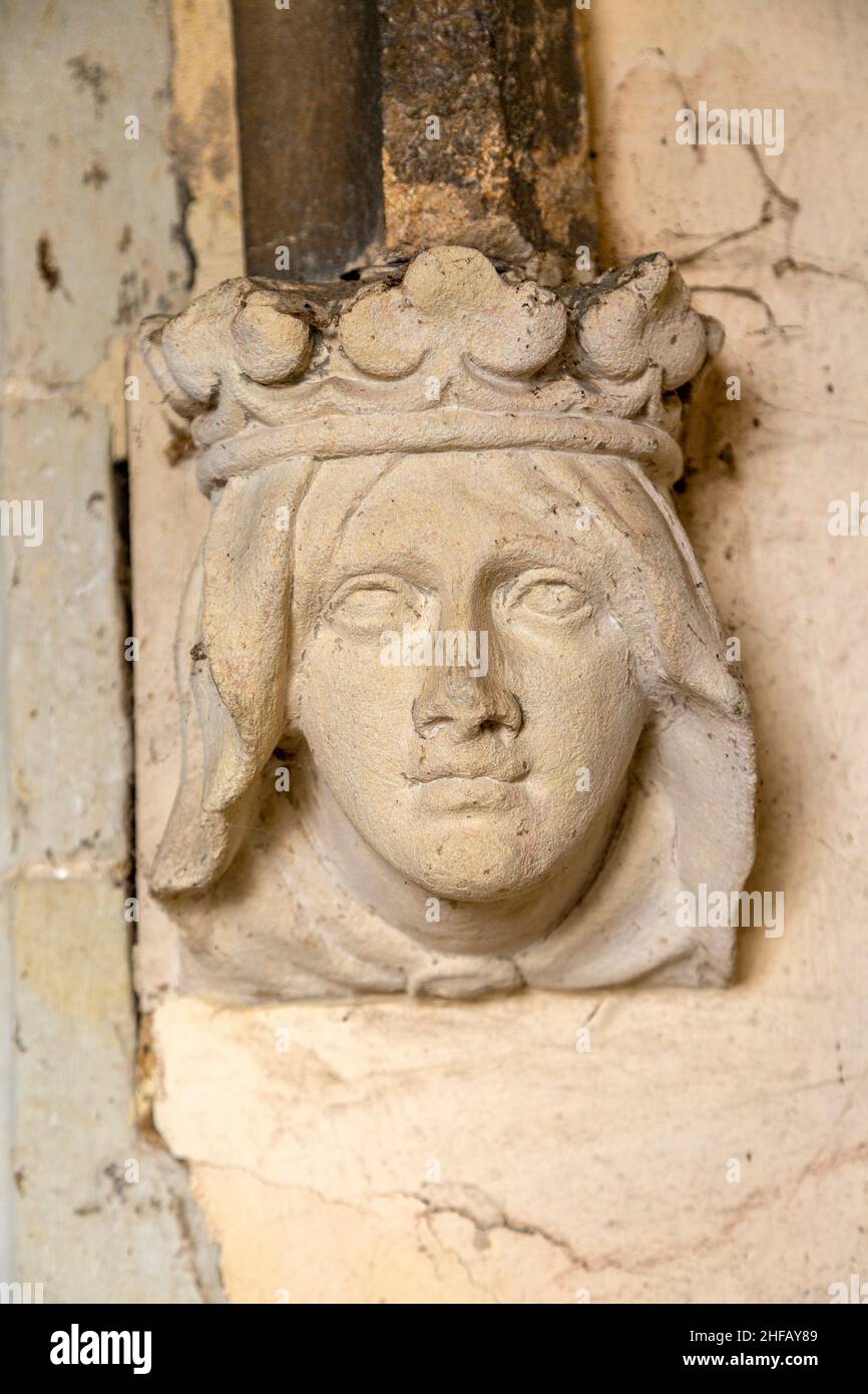 Stone carving female headstop on doorway surround wearing a crown Assington church, Suffolk, England, UK Stock Photo