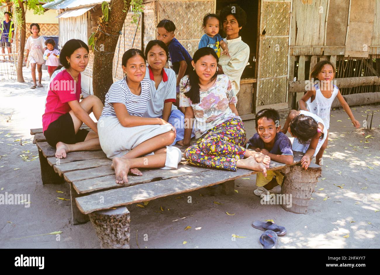 A friendly family in their village on Olango Island shelters from the