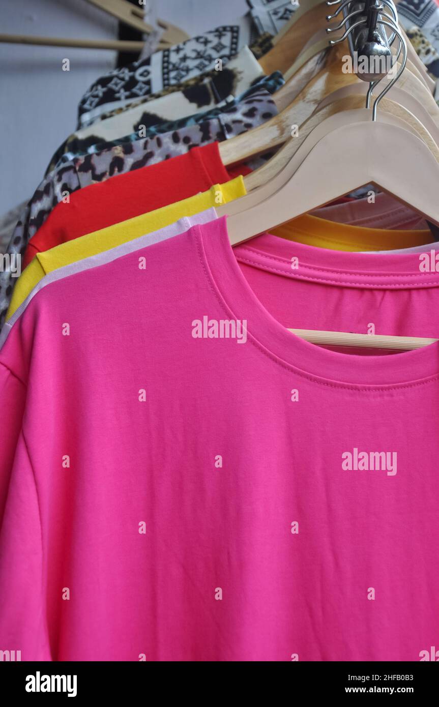 https://c8.alamy.com/comp/2HFB0B3/multicolored-t-shirts-and-shirts-hanging-on-hangers-in-shop-for-sale-stock-photo-2HFB0B3.jpg