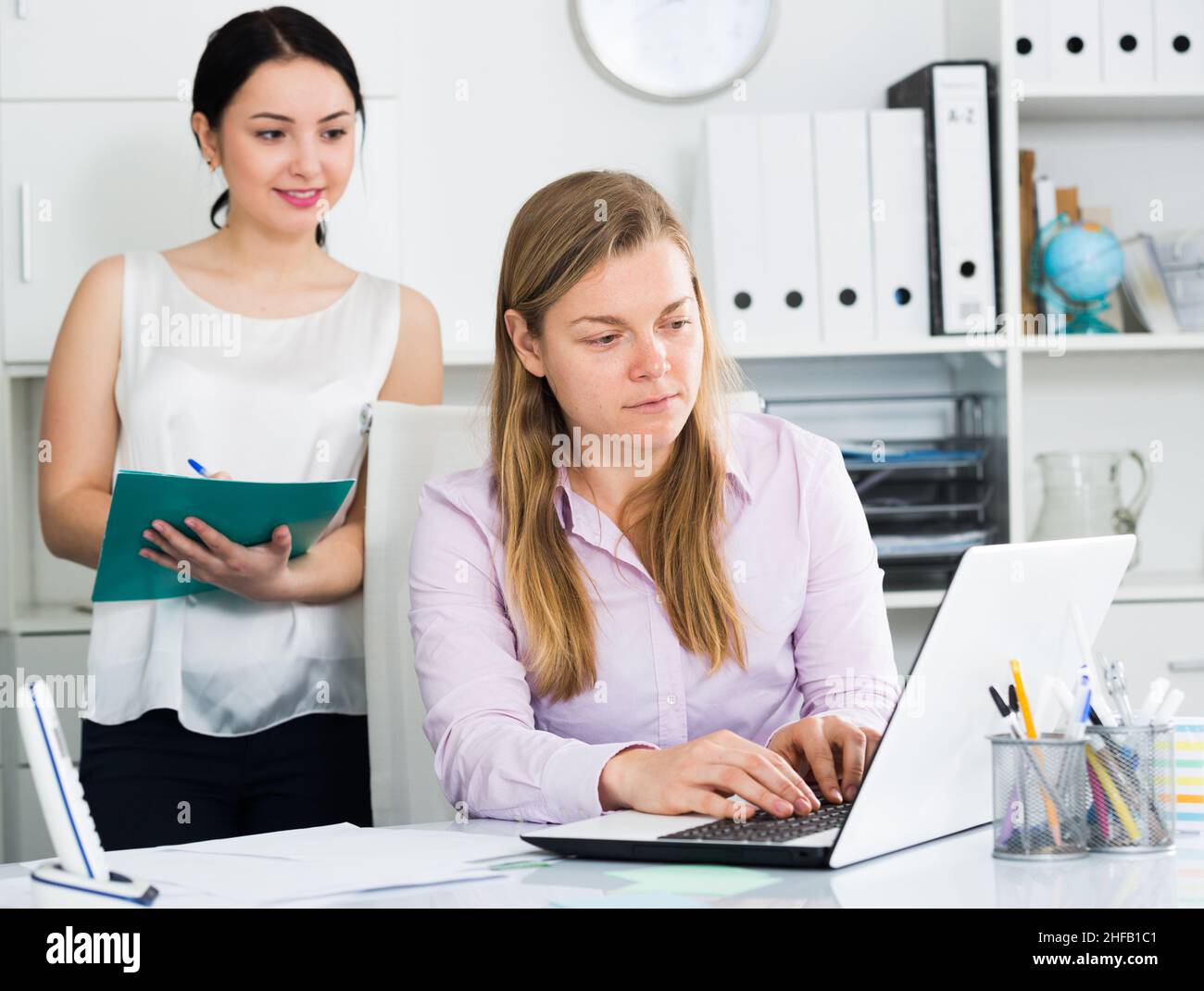 Manager inspecting work Stock Photo - Alamy