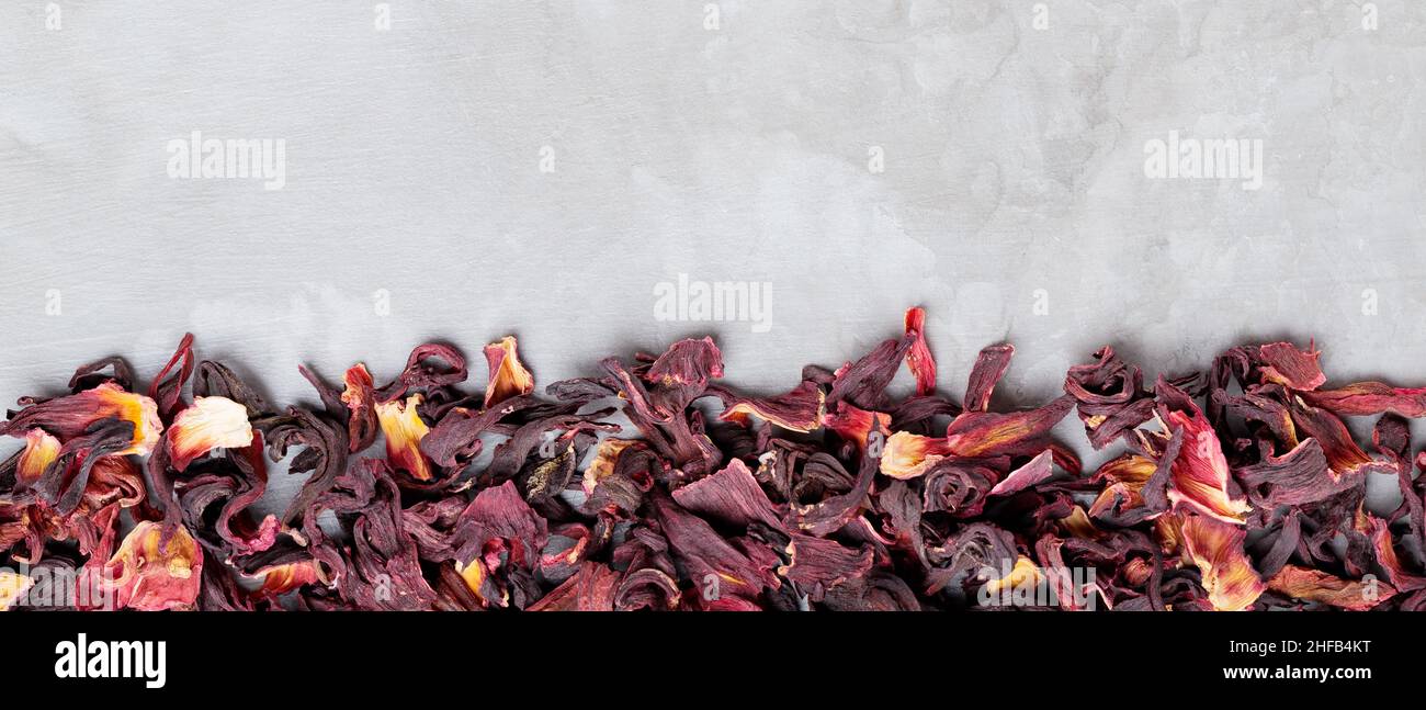 Dry hibiscus petals on gray background. Flowers red hibiscus tea on a ...