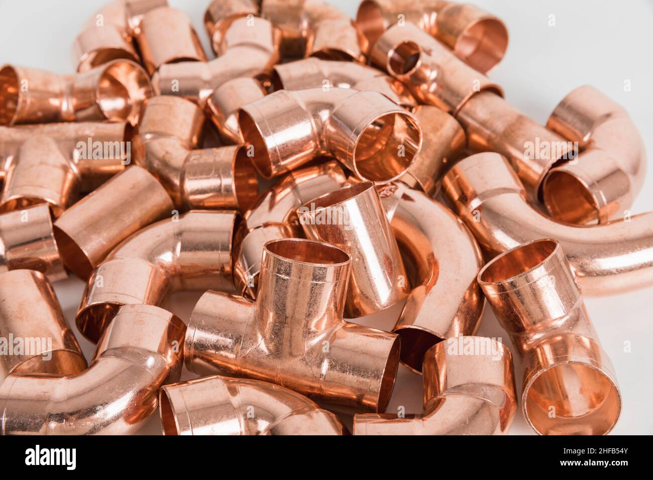 Group of fittings on a white background. Copper fittings for pipe connections. Technical basis