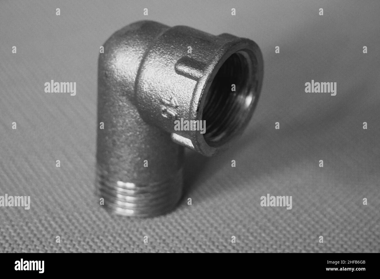 Brass transition elbow with external-internal thread. Spare part close-up. Stock Photo